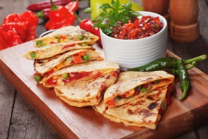 Mexican quesadillas with cheese, vegetables and salsa dipping sa
